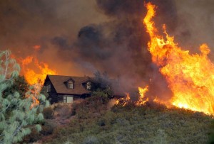 home surrounded by wildfires